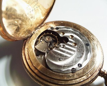 Featured is a photo of the internal workings of a pocket watch.